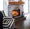 Warm gas fireplace with cozy chair next to it